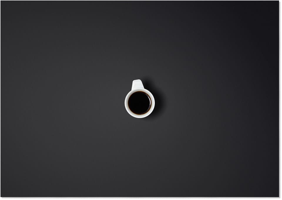CUP OF COFFEE IN BLACK SPACE